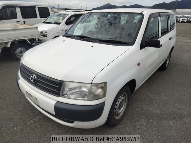 A grey JDM sports car speeding down a highway at night.
