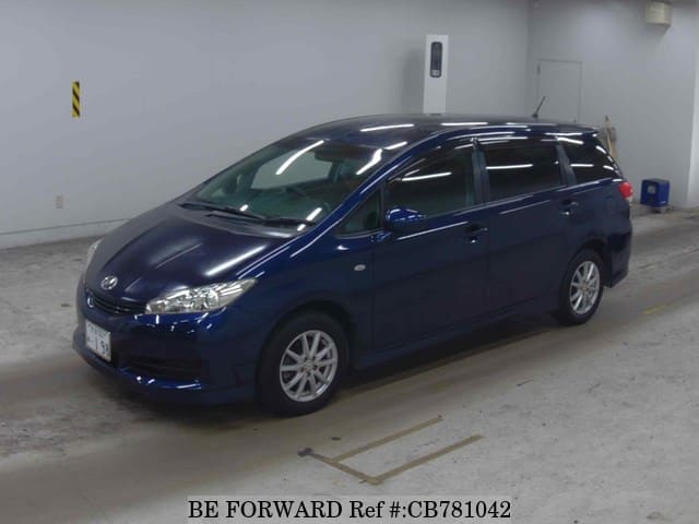 A grey JDM sports car speeding down a highway at night.