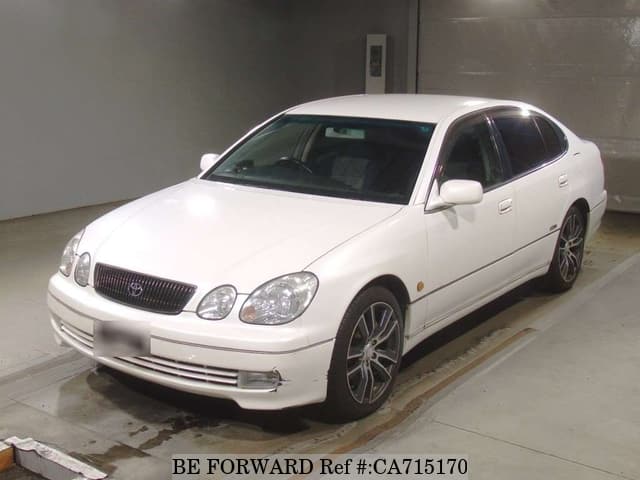 A grey JDM sports car speeding down a highway at night.
