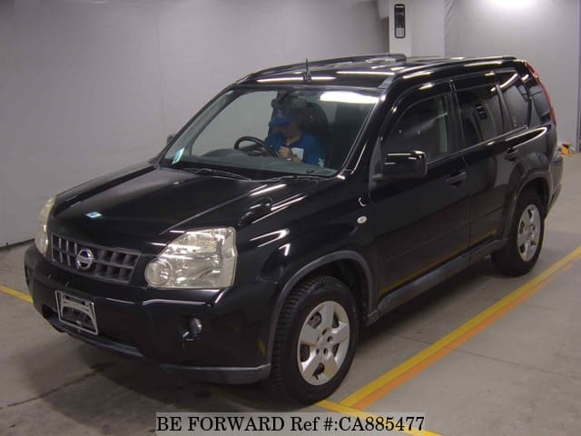 A grey JDM sports car speeding down a highway at night.