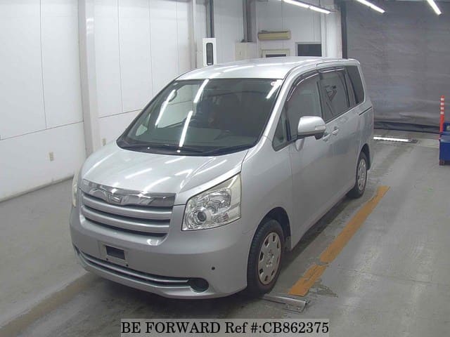 A grey JDM sports car speeding down a highway at night.