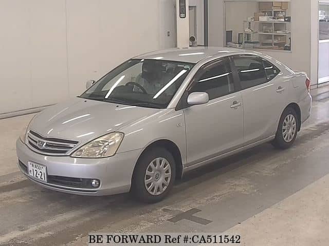 A grey JDM sports car speeding down a highway at night.