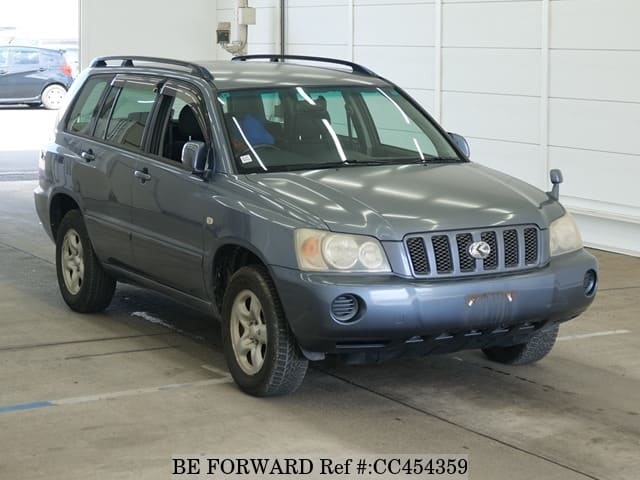 A grey JDM sports car speeding down a highway at night.