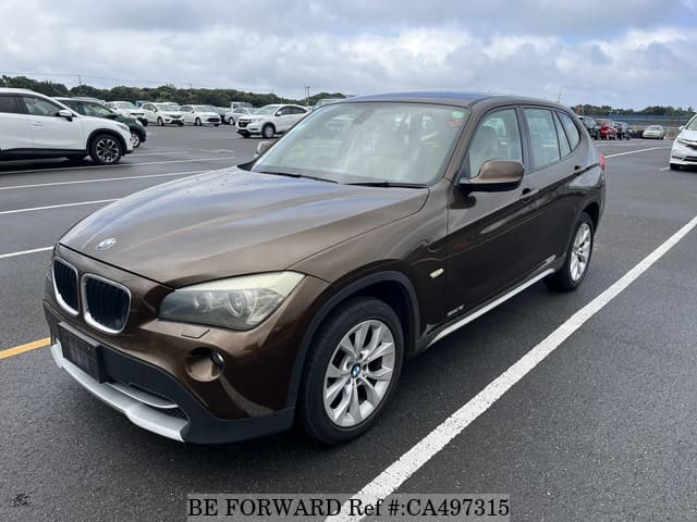 A grey JDM sports car speeding down a highway at night.