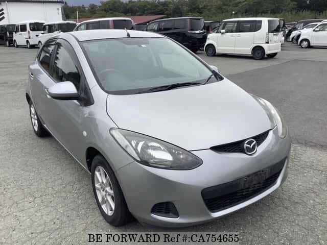 A grey JDM sports car speeding down a highway at night.
