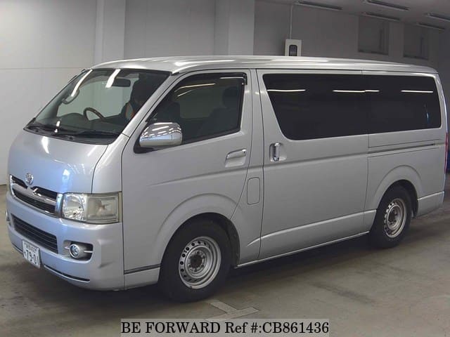 A grey JDM sports car speeding down a highway at night.