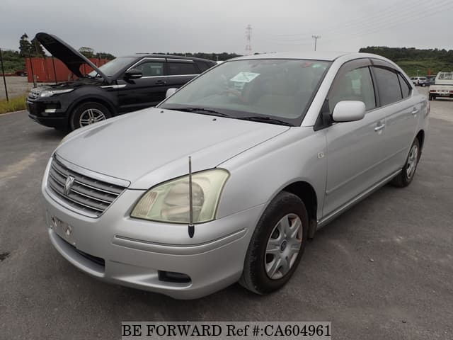 A grey JDM sports car speeding down a highway at night.