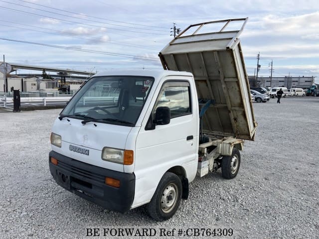 A grey JDM sports car speeding down a highway at night.