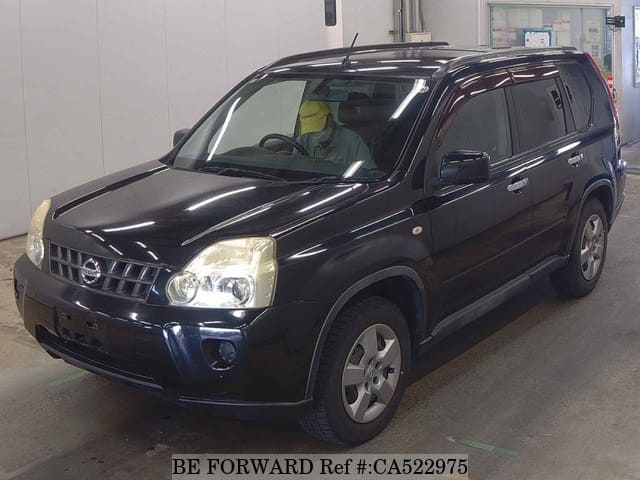 A grey JDM sports car speeding down a highway at night.