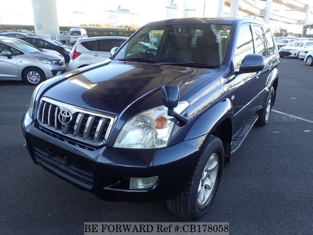 A grey JDM sports car speeding down a highway at night.