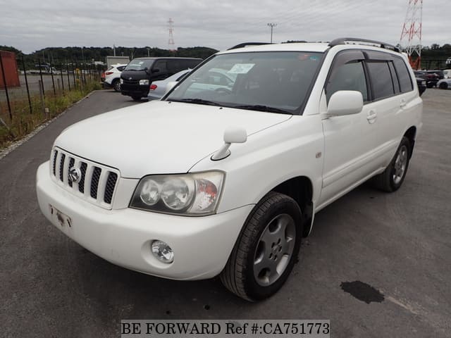 A grey JDM sports car speeding down a highway at night.