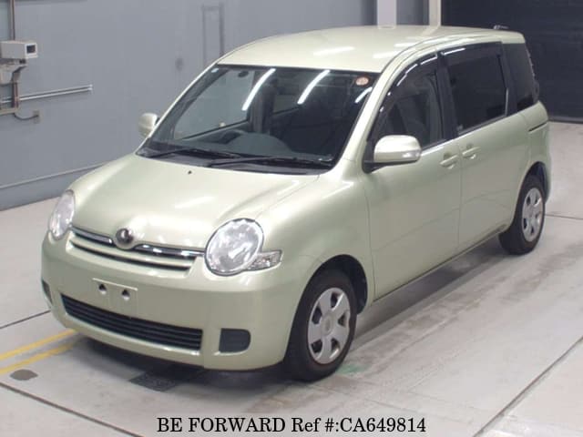 A grey JDM sports car speeding down a highway at night.