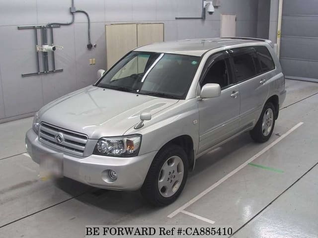 A grey JDM sports car speeding down a highway at night.