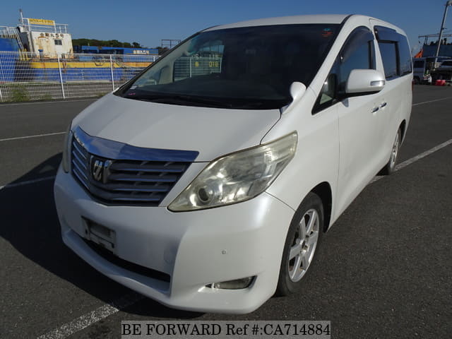 A grey JDM sports car speeding down a highway at night.