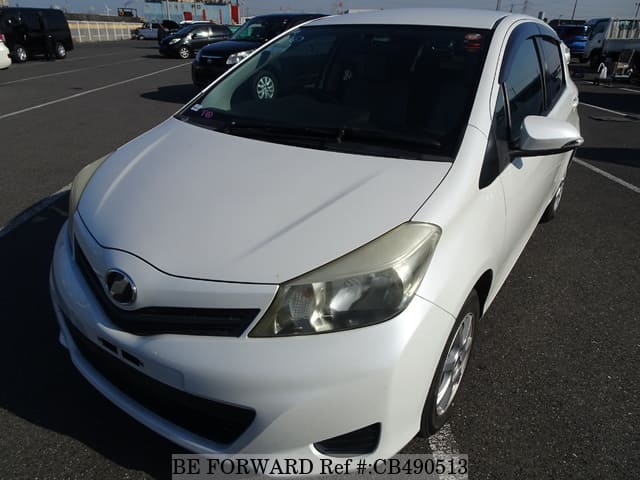 A grey JDM sports car speeding down a highway at night.