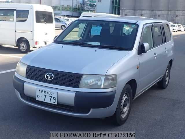 A grey JDM sports car speeding down a highway at night.