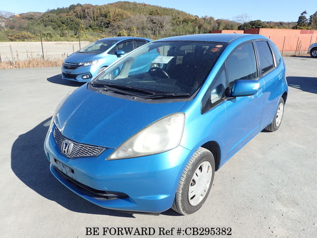 A grey JDM sports car speeding down a highway at night.