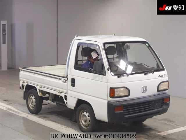 A grey JDM sports car speeding down a highway at night.