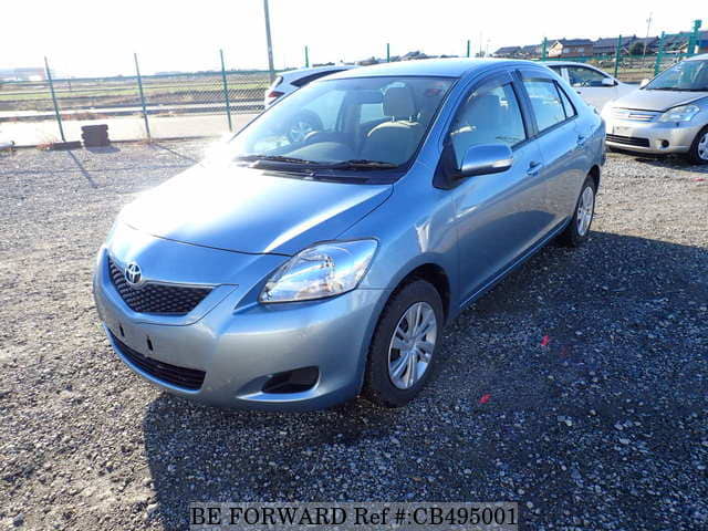 A grey JDM sports car speeding down a highway at night.
