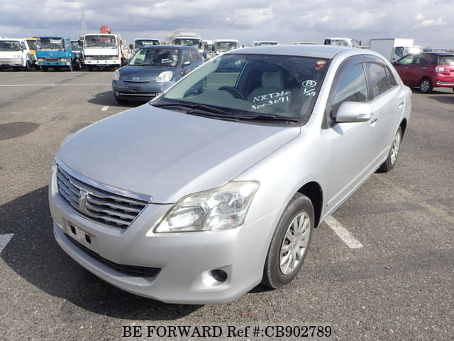 A grey JDM sports car speeding down a highway at night.