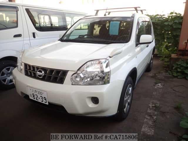 A grey JDM sports car speeding down a highway at night.