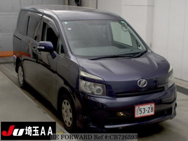 A grey JDM sports car speeding down a highway at night.