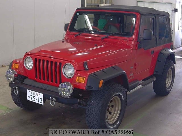 A grey JDM sports car speeding down a highway at night.