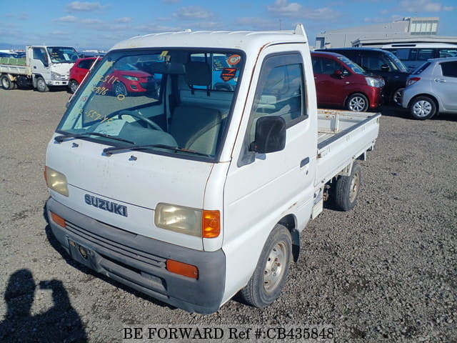 A grey JDM sports car speeding down a highway at night.