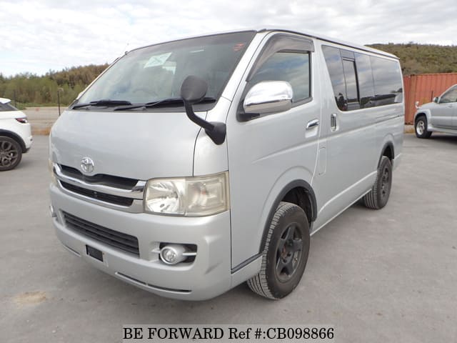 A grey JDM sports car speeding down a highway at night.