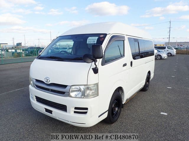 A grey JDM sports car speeding down a highway at night.