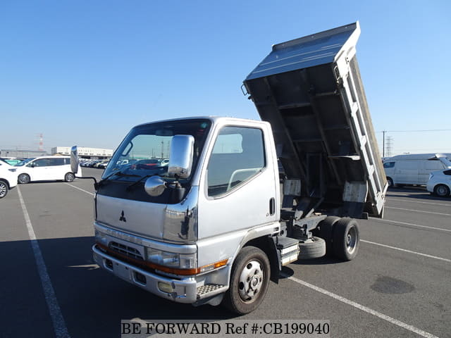 A grey JDM sports car speeding down a highway at night.