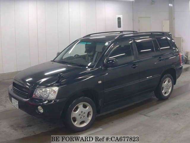 A grey JDM sports car speeding down a highway at night.