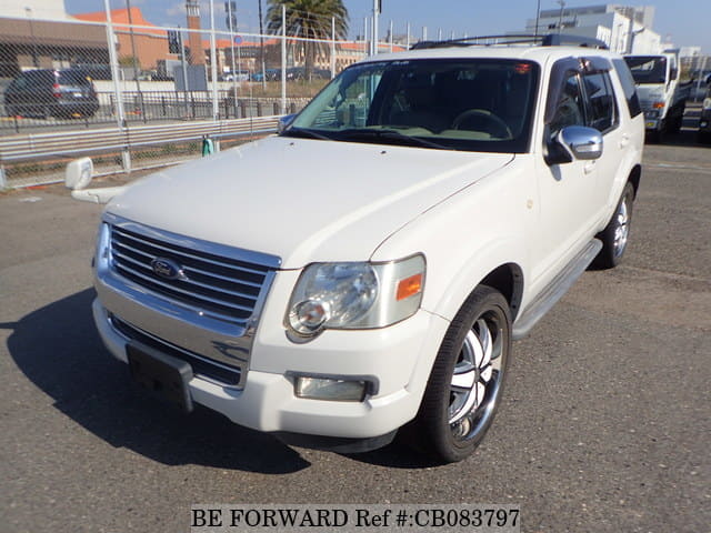 A grey JDM sports car speeding down a highway at night.
