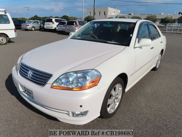 A grey JDM sports car speeding down a highway at night.