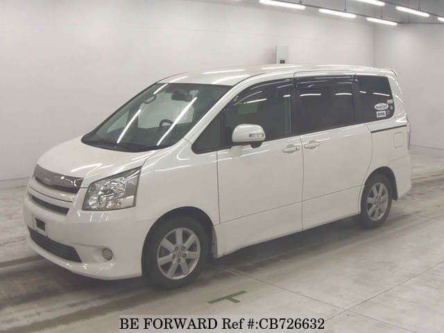 A grey JDM sports car speeding down a highway at night.