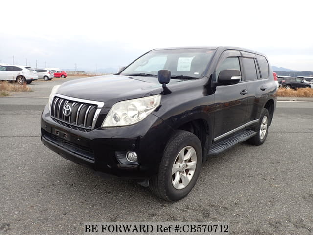 A grey JDM sports car speeding down a highway at night.