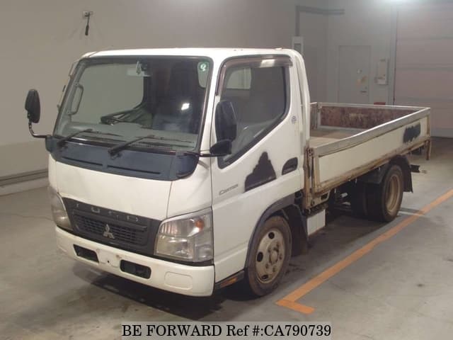 A grey JDM sports car speeding down a highway at night.