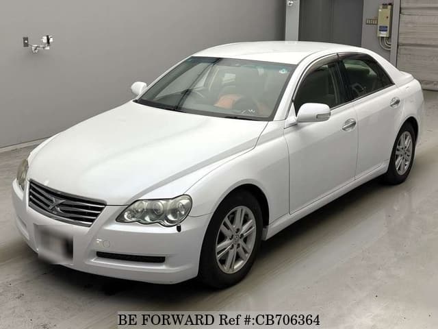 A grey JDM sports car speeding down a highway at night.