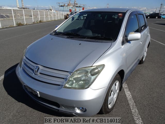 A grey JDM sports car speeding down a highway at night.