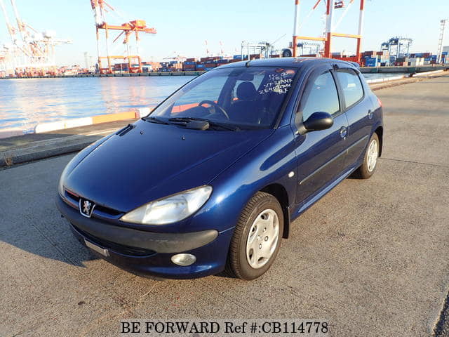 A grey JDM sports car speeding down a highway at night.