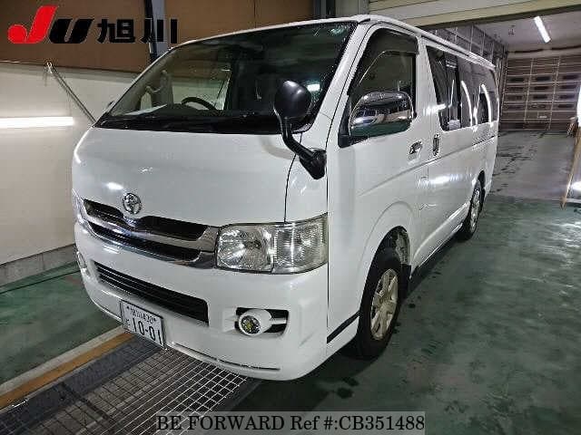 A grey JDM sports car speeding down a highway at night.