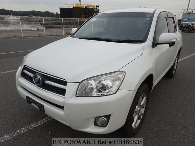 A grey JDM sports car speeding down a highway at night.