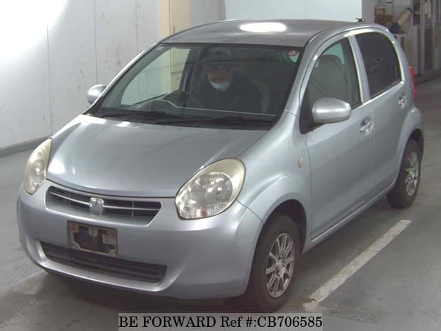 A grey JDM sports car speeding down a highway at night.