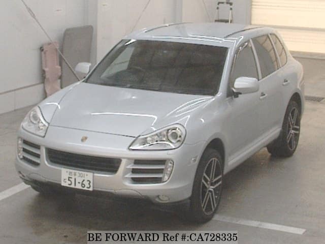 A grey JDM sports car speeding down a highway at night.