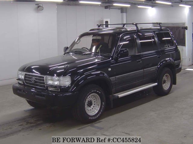 A grey JDM sports car speeding down a highway at night.