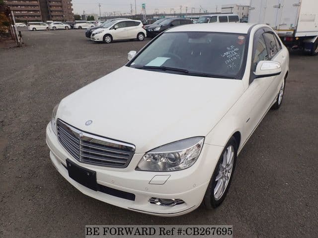 A grey JDM sports car speeding down a highway at night.