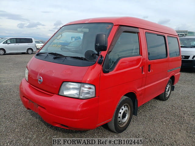 A grey JDM sports car speeding down a highway at night.
