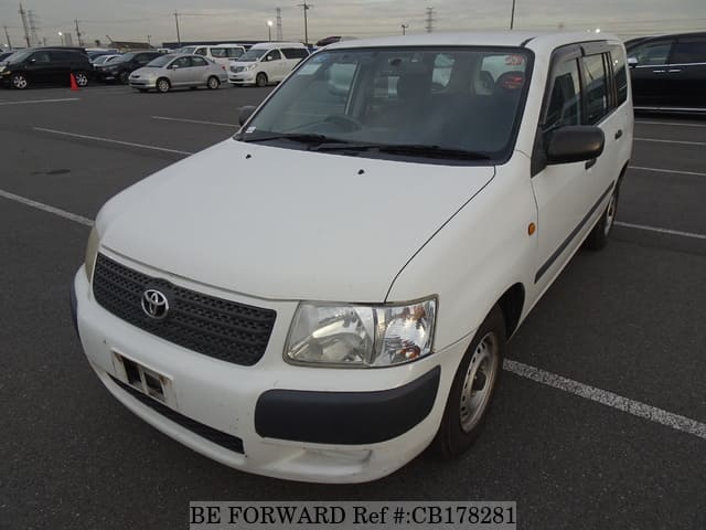 A grey JDM sports car speeding down a highway at night.