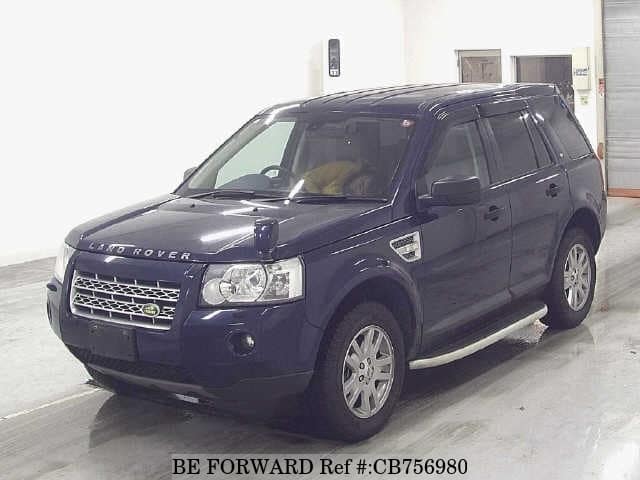 A grey JDM sports car speeding down a highway at night.