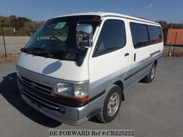 A grey JDM sports car speeding down a highway at night.